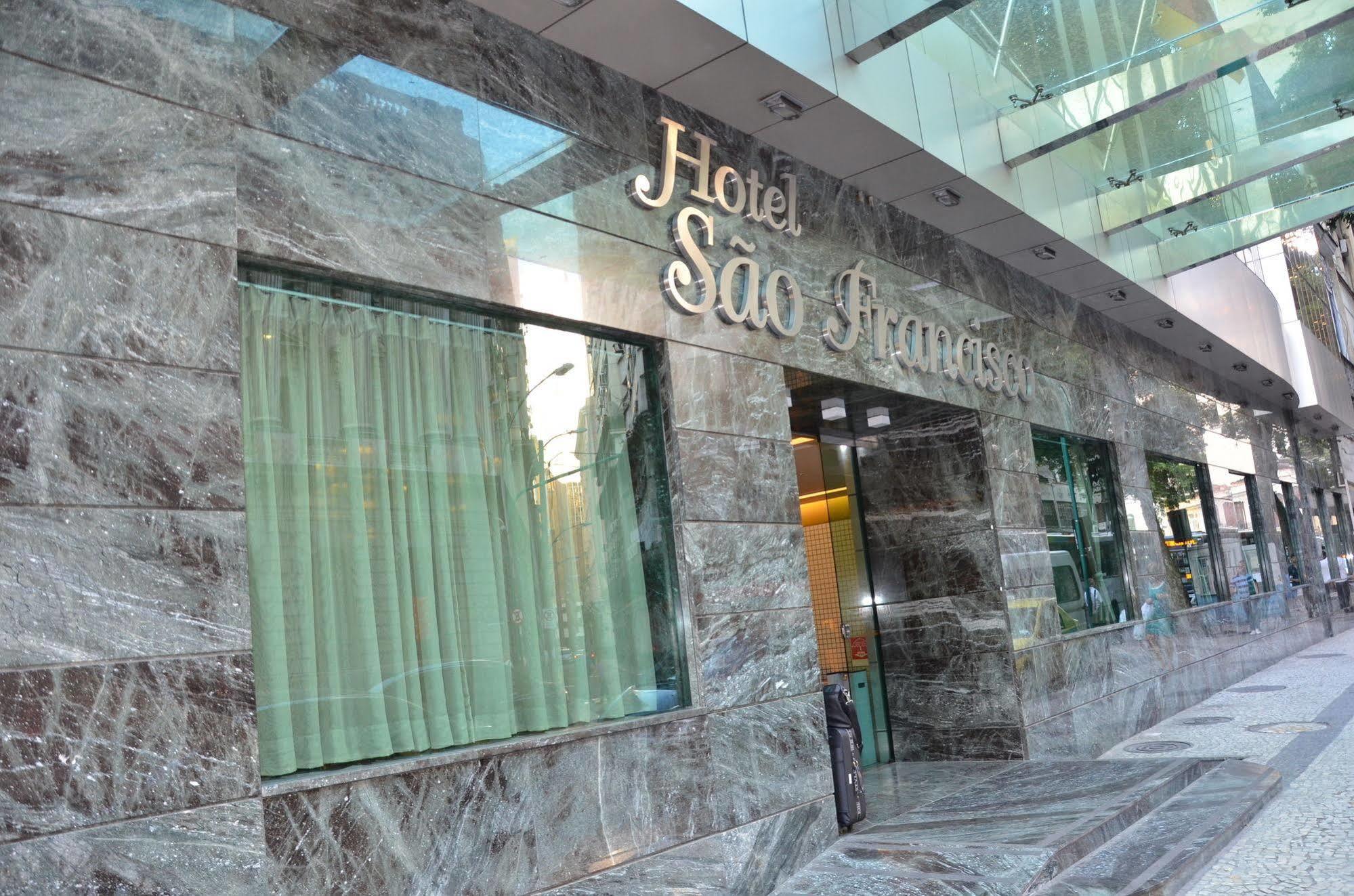 Hotel Atlantico Tower Rio de Janeiro Exteriér fotografie The photo shows the exterior of a hotel named "Hotel São Francisco." The facade is made of marble, giving it an elegant appearance, and large glass windows are visible, likely allowing natural light to enter the interior. There are light green curtai